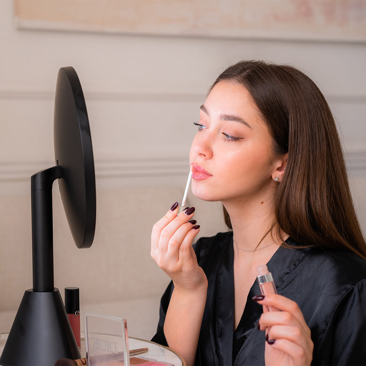 Woman applying lipstick in front of a 5x magnification mirror as beauty gift set for women