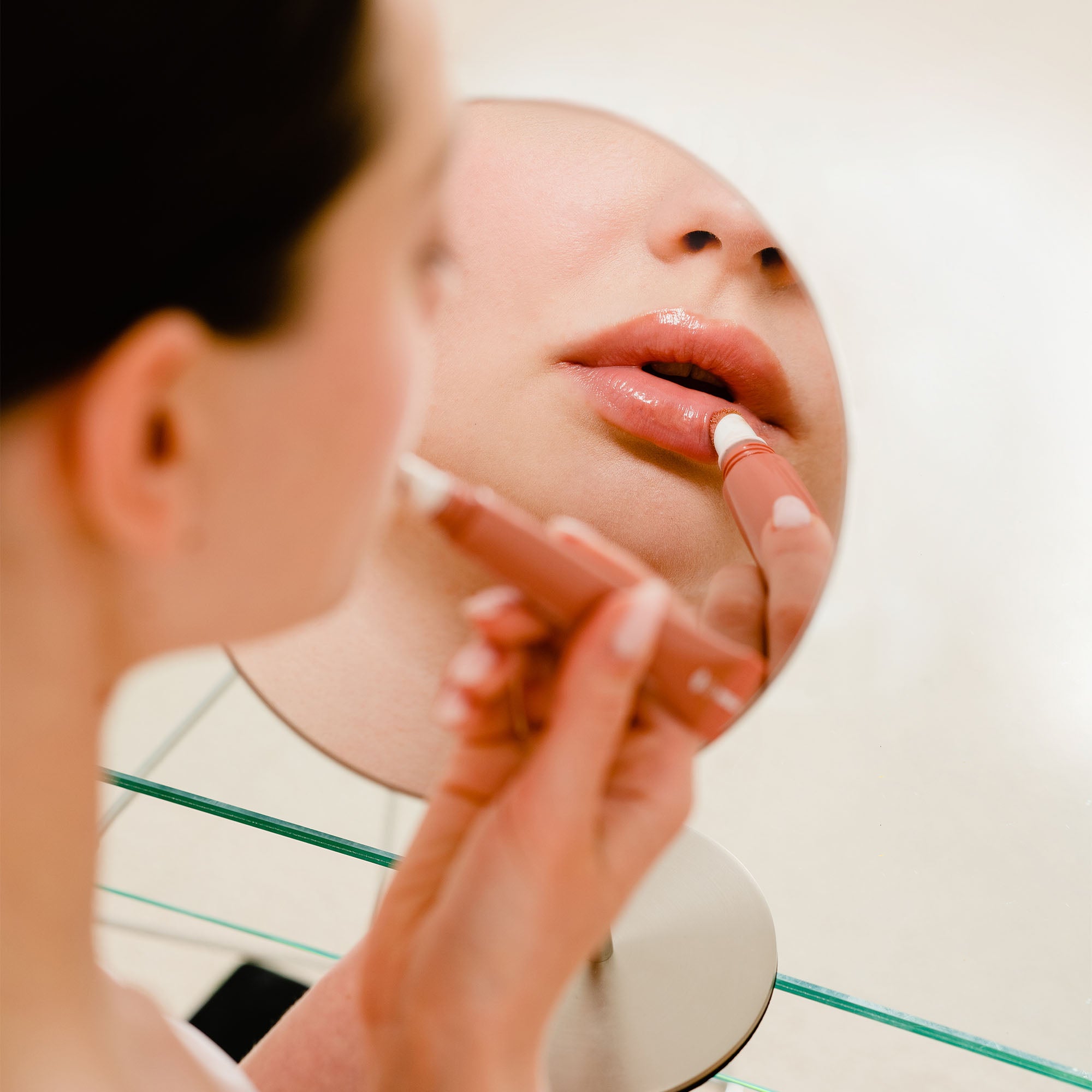 Person applying lipstick in front of a mirror_#Silver_Silver