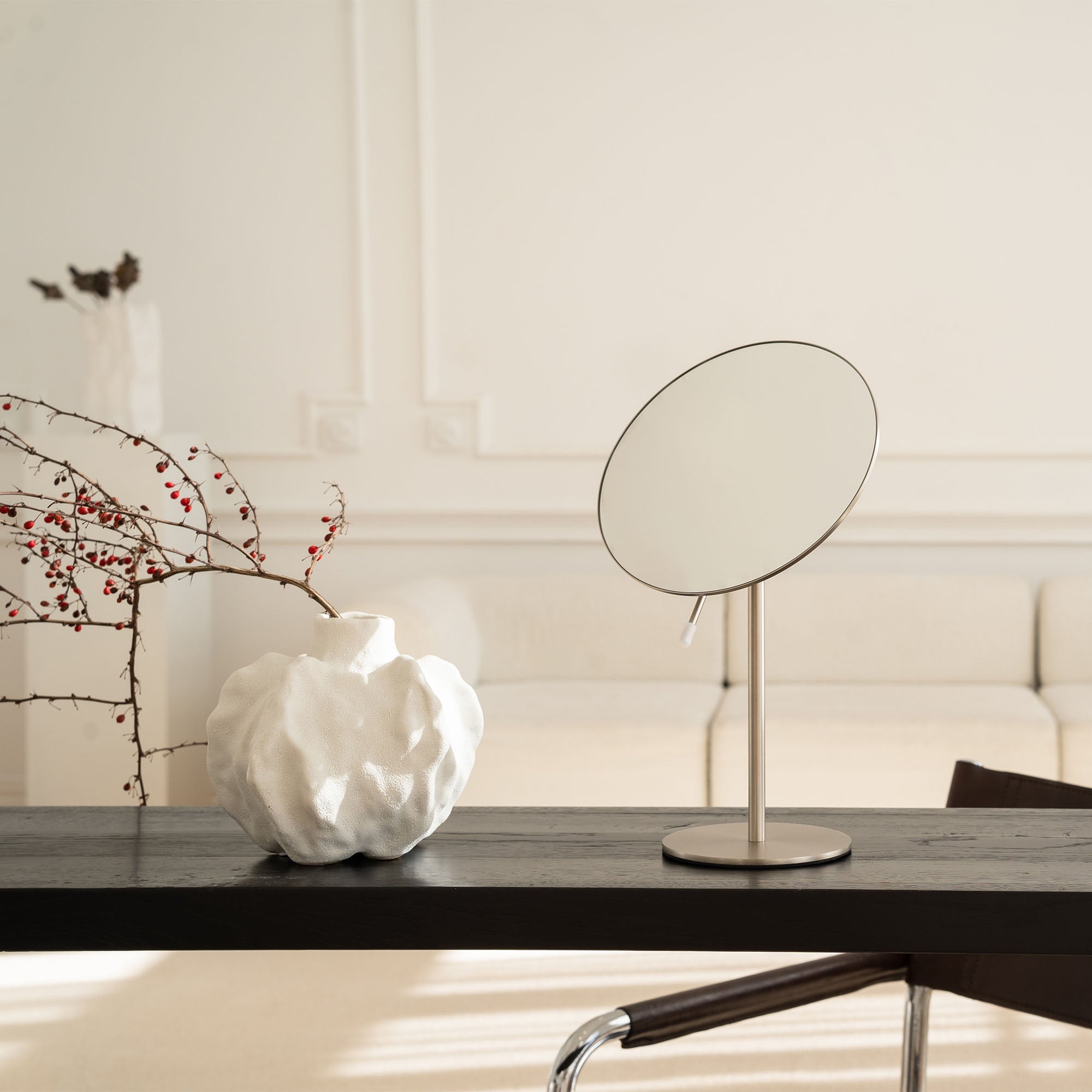 Tabletop mirror and decorative vase on a wooden table with a neutral background_#Silver_Silver