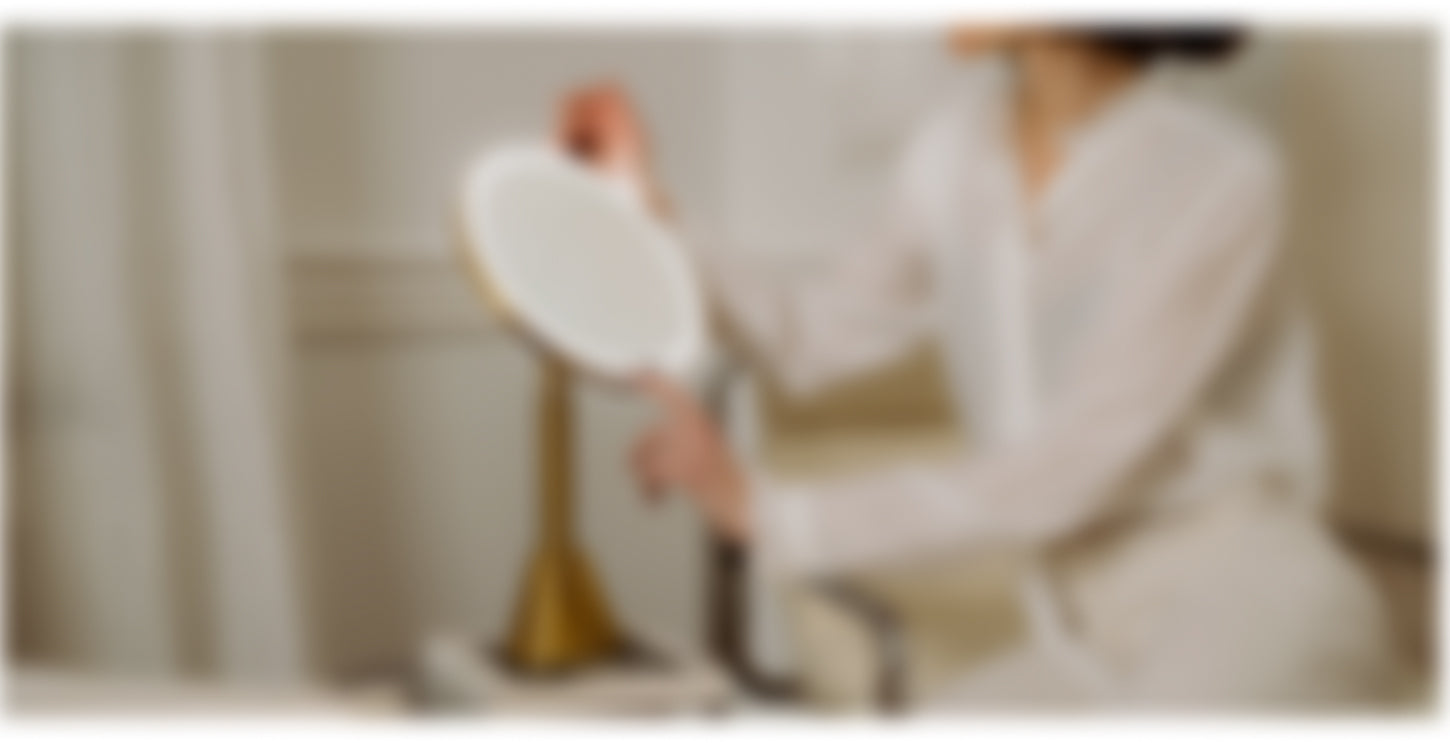 Person holding a white plate with a blurred background